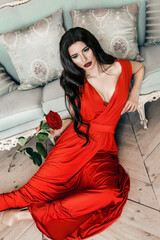 Perfect Woman Resting in Vintage Interior. Glamorous Brunette Model wearing Red Dress