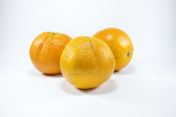 Fresh oranges isolated on white background. Freshly picked oranges. Close up.