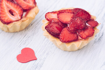 Cake with fresh strawberries and red heart