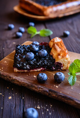 Slice of juicy homemade yeast pie with blueberry