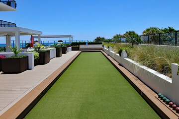 Inviting outdoor terrace and bocce ball court with artificial turf.