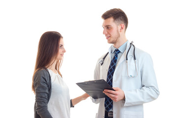 beautiful patient looks at a primary care physician in the white robe is isolated on a white background