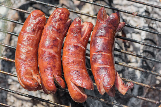Grilling sausages on barbecue grill 