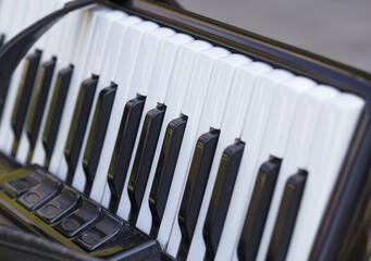 Accordion, old used musical instrument close up background.