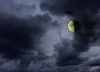 Moon in the night cloudy sky