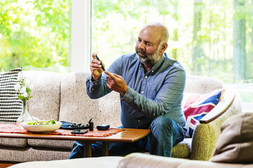 Mature, diabetic, ethnic man in his 50's checking his blood sugar