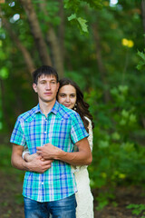 Fototapeta premium Portrait of a young romantic couple embracing each other on nature