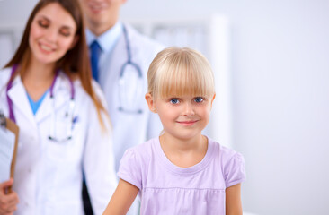 Female doctor examining child with stethoscope at surgery