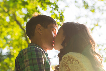 Fototapeta premium Young attractive couple in love kissing in summer nature