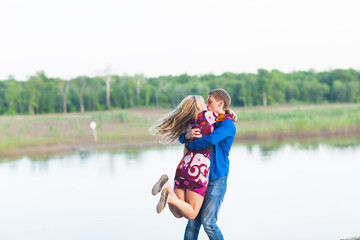 Fototapeta na wymiar beautiful young couple in love embracing near the lake.