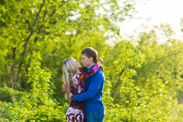 Fototapeta premium beautiful young love couple hugging in the park