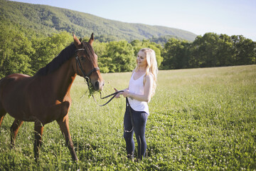 Blonde Female with her Horse in a Rural Meadow