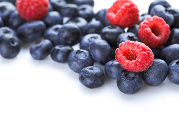 Blueberry and raspberries on white background