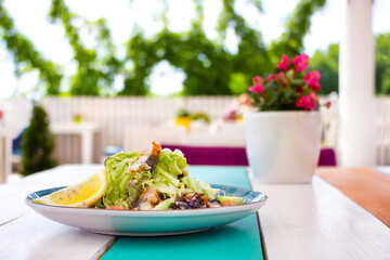 Tasty fresh eel salad on the white wooden table in summer terrace