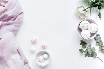 sweet marsh-mallow and flowers on woman white desk background top view mockup