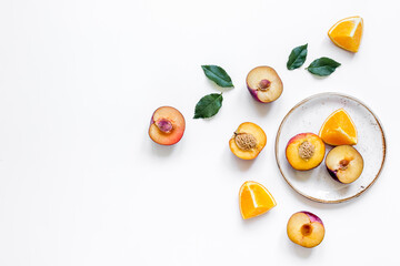 orange and peach summer sweet dessert on plates white background top view mock-up