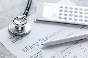 health care billing statement with doctor's stethoscope on stone background
