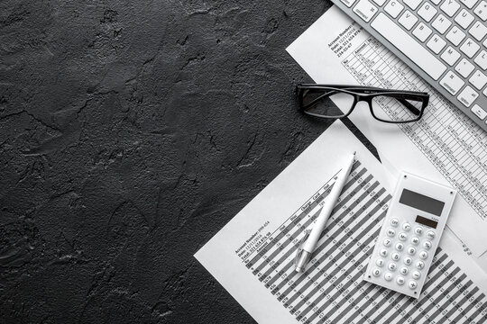 taxes accounting in office work space on dark desk background top view mockup