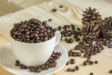 close up coffee beans in cup with  wooden background, selective focus and effect filter.
