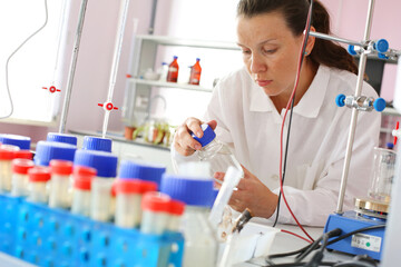 A student girl conducting experiments in chemical laboratory