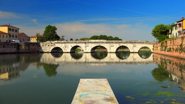 pier in front of ancient Roman bridge in Rimini, Italy