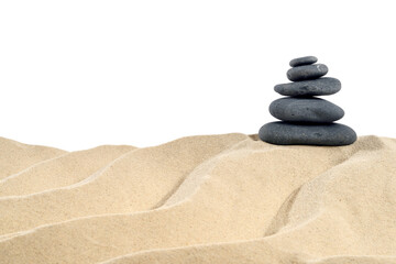 Fototapeta na wymiar On the Beach - Balanced stones on a sand dune in front of a white background - clipping path included 