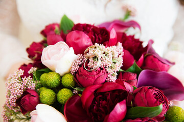Engagement rings on beautiful wedding bouquet