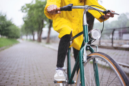 Cropped shot of bicycle rider wearing raincoat