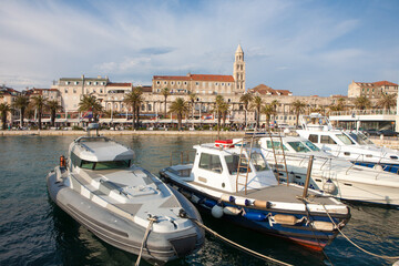 Fototapeta na wymiar The Diocletian Palace from the harbor with ships in the front in Split City, Croatia