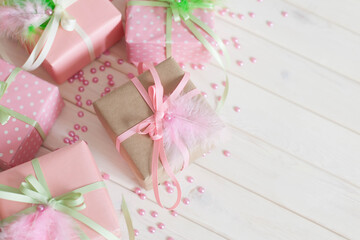 Pink gift boxes. Feathers, rhinestones, flowers and scrapbooking.