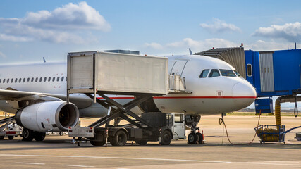 Fototapeta na wymiar Passenger jet airplane docked on airport gate