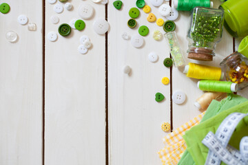 Materials for sewing. Colored fabric, thread and buttons on a white background. Needle bed with...