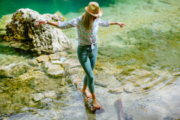 woman balancing on wood log