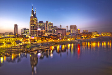 Fototapeta na wymiar Skyline of Nashville, Tennessee at sunset showing reflections in the Cumberland River