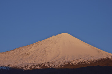 Fototapeta na wymiar Snow capped peak of Antuco Volcano (2,979 metres) in Laguna de Laja National Park in the Bio Bio region of Chile.