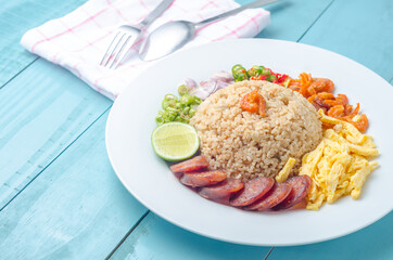 Rice Seasoned with Shrimp Paste, Thai food on white dish over wooden table.