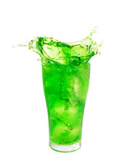 Green soft drink splashing out of glass isolated on white background.