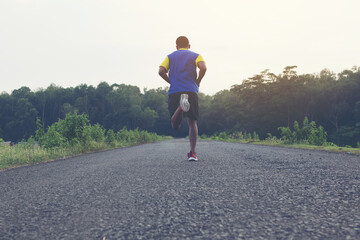 man running and jogging on road ; Healthy lifestyle with outdoors summer 
