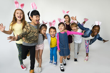 Group of Kids Wearing Bunny Ears for Easter Happiness Smiling on White Blackground