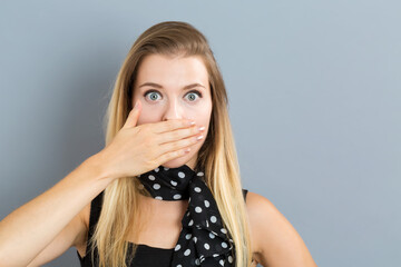 Young woman covering her mouth