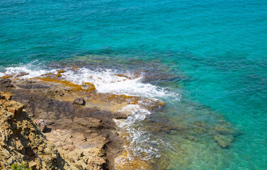 Fototapeta na wymiar Rocks and ocean waves. Antigua, English Harbour