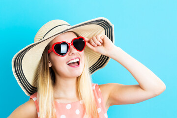 Fototapeta premium Happy young woman wearing hat and sunglasses