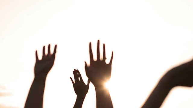 Golden hipster hand silhouettes waving in the sunlight living life