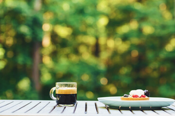 Desserts and coffee with a forest background