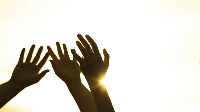 Golden hipster hand silhouettes waving in the sunlight living life - V2