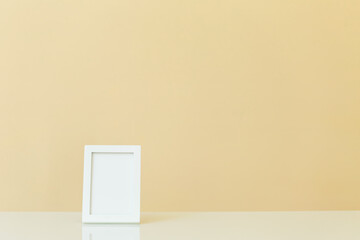 Blank picture frame on a yellow background