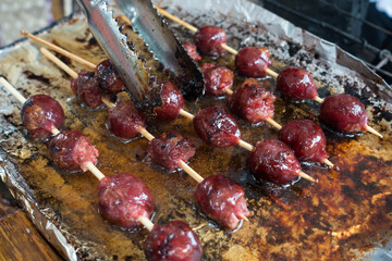 sausage fried on silver paper