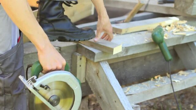 Saw boards electric saw in the nature