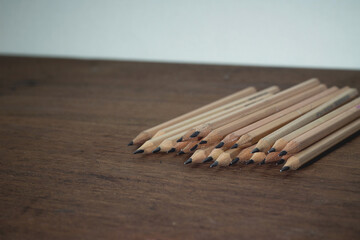 Group pencil place on the wooden table.
