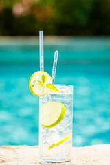Water with ice at the edge of a resort pool. Concept of luxury vacation